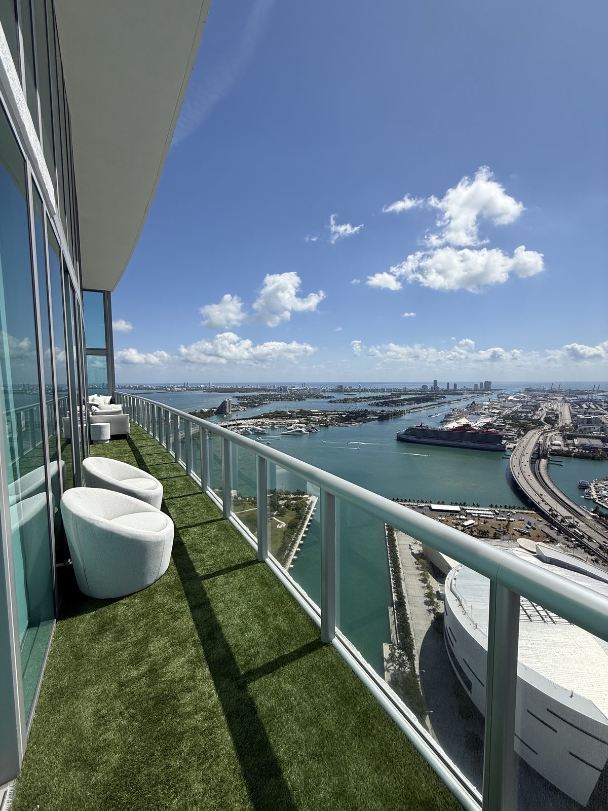 A penthouse balcony overlooking Biscayne Bay and the Port of Miami