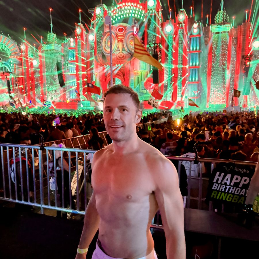 Adam Young in front of the glowing EDC main stage