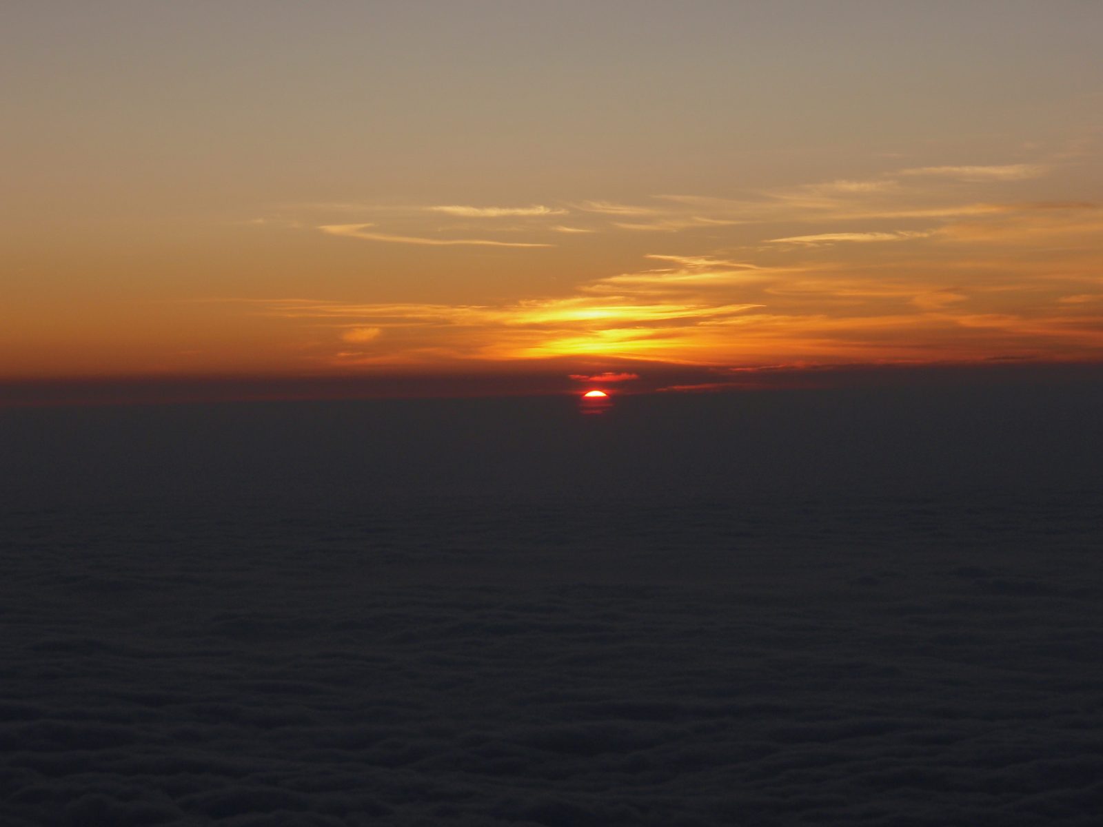 Sunrise breaking over a sea of clouds seen from high on Kilimanjaro