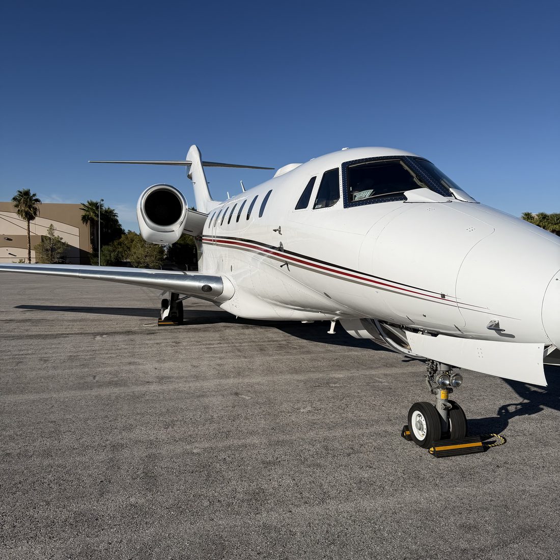 A private jet parked on a sunny tarmac